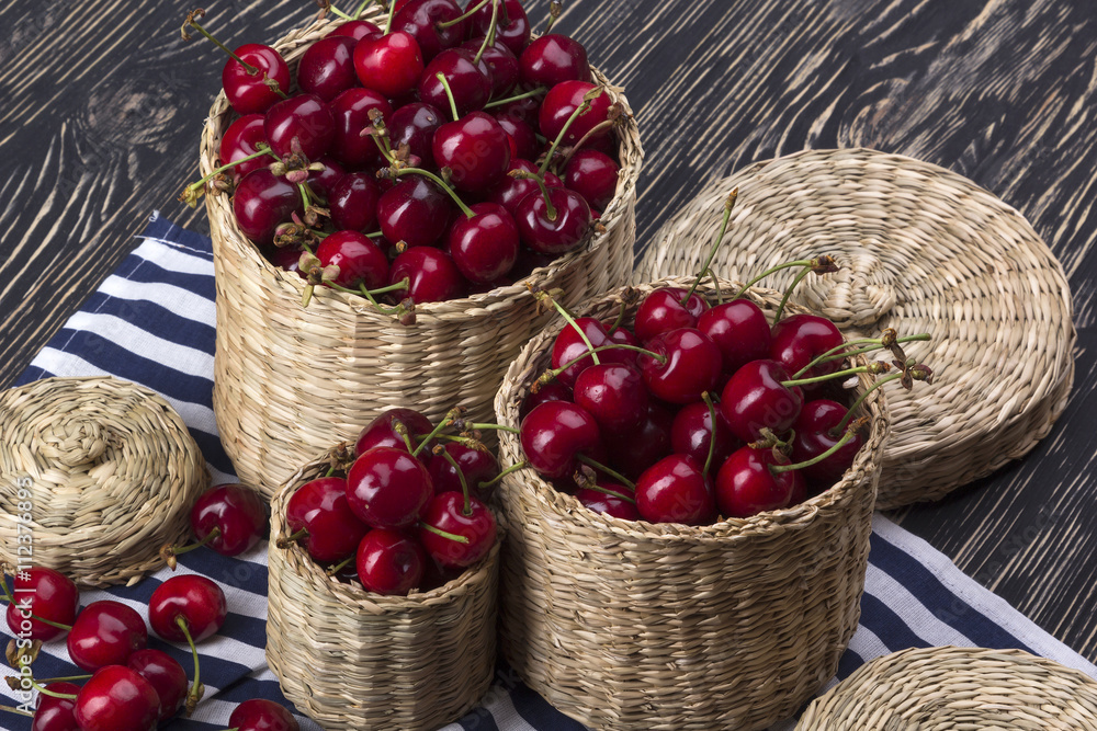 Cherry baskets on wooden background Cherry baskets on wooden background