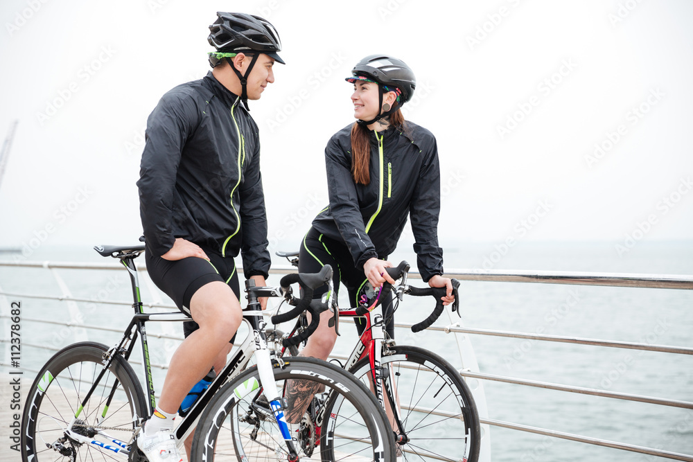 Couple on bicycle resting and flirting Couple on bicycle resting and flirting