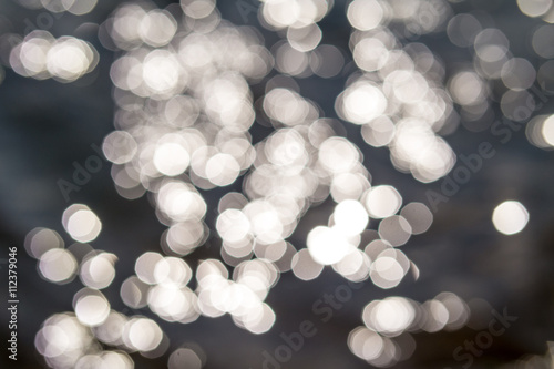 Abstract background with bokeh sun lights in the lake.