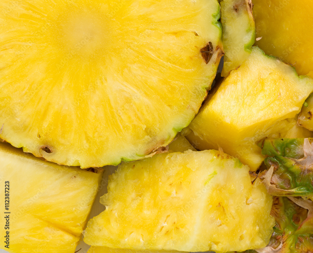 A fresh pineapple on a cutting board close view A fresh pineapple on a cutting board close view