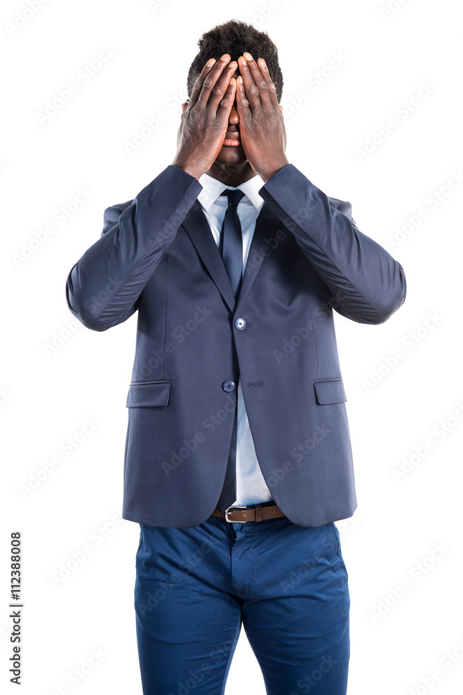 Handsome black man covering his face Handsome black man covering his face