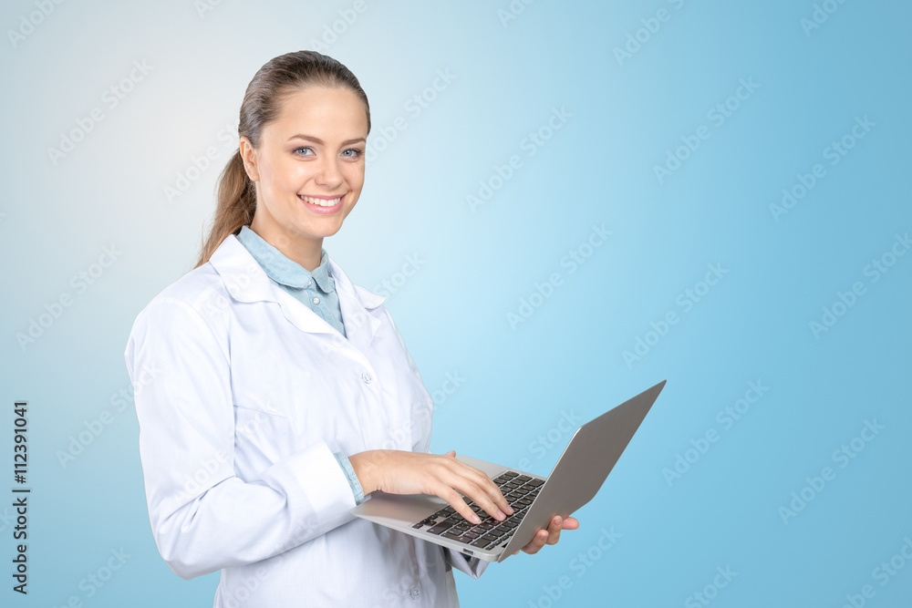 Attractive female doctor working on her laptop Attractive female doctor working on her laptop