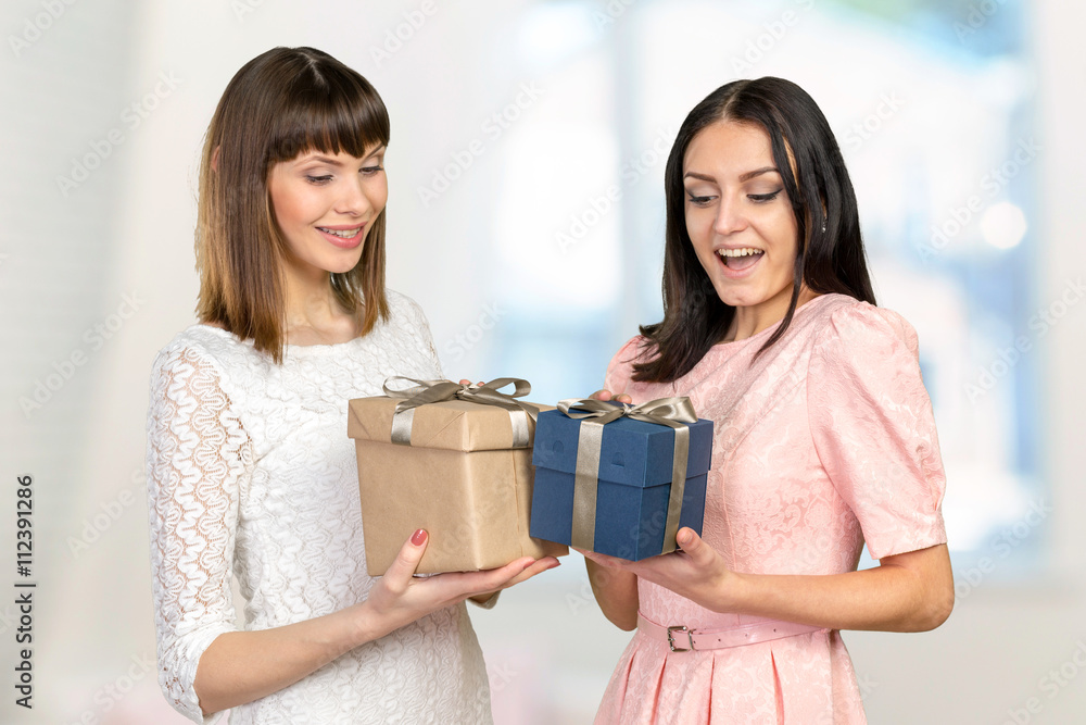 Two women exchanging gifts Two women exchanging gifts