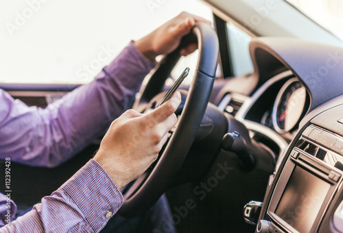 Close-up of a male hand in a modern car