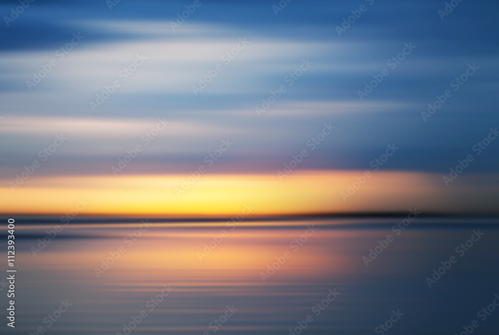 Colorful sunset over sea coast under blue sky