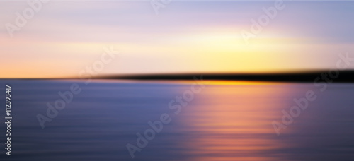 Colorful sunset over sea coast. Blurred photo