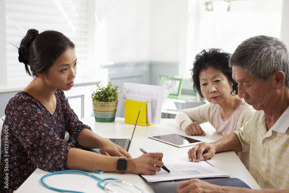 Serious Senior Couple Meeting With Doctor In Office Serious Senior Couple Meeting With Doctor In Office