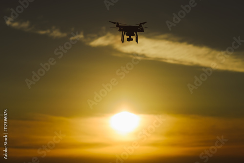 Silhouette drone / quadcopter at sunset