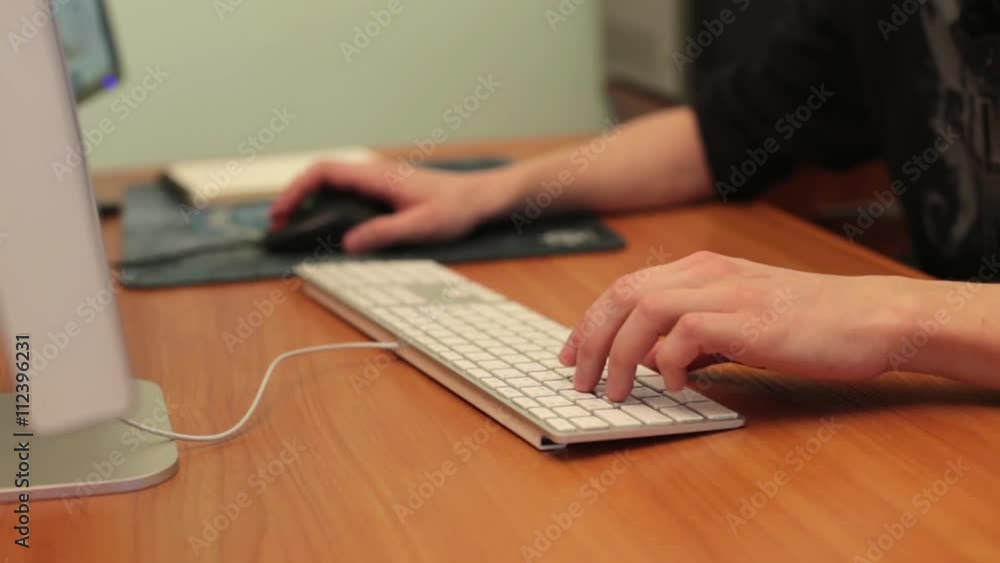 The designer working behind two monitors The designer working behind two monitors