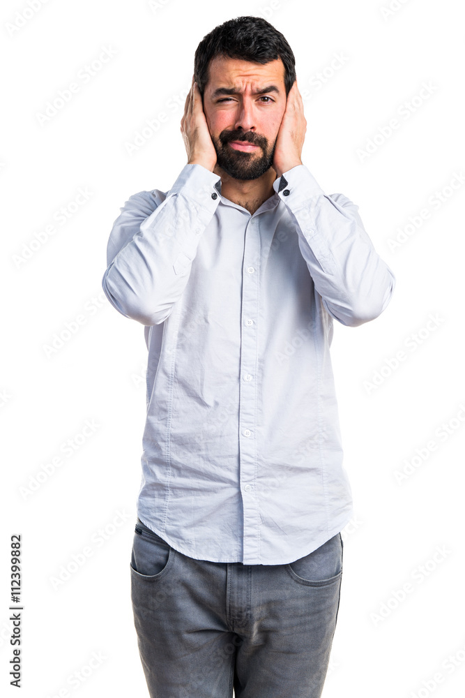 Man covering his ears Man covering his ears