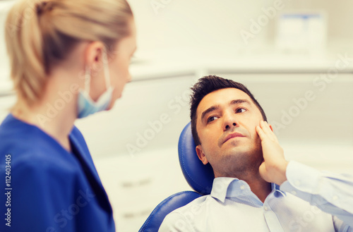 female dentist and male patient with toothache