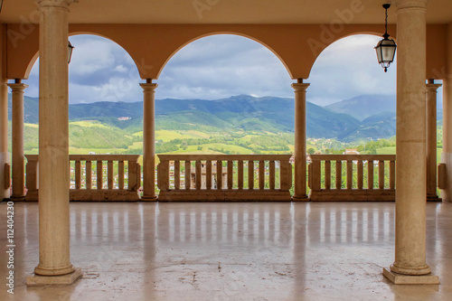 Panorama of hills in Umbria, Italy, seen through three arches photo