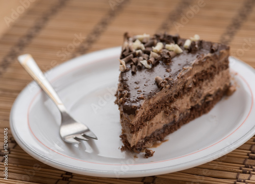 Slice of chocolate cake  garnished with nuts
