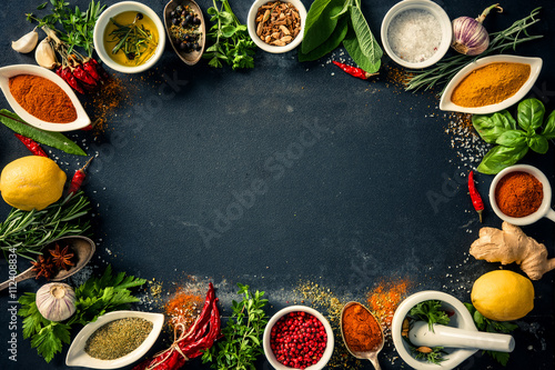 Fototapeta Naklejka Na Ścianę i Meble -  Herbs and spices over black stone background