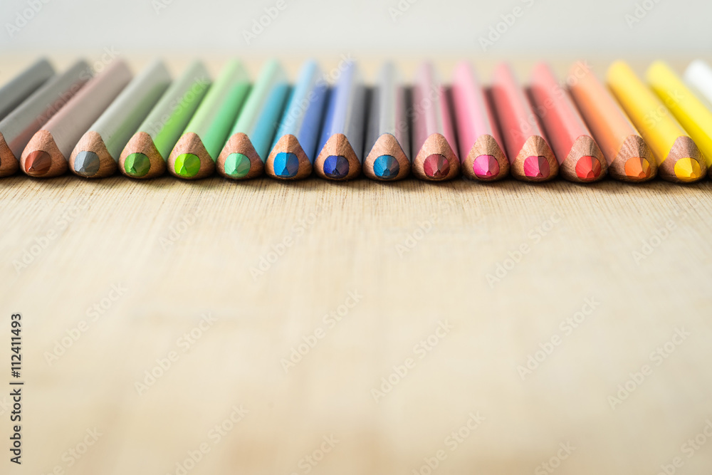 Obraz premium Color Pencils on wood texture. Macro shot of colorful pencils. Horizontal view of pencils. Selective focus.