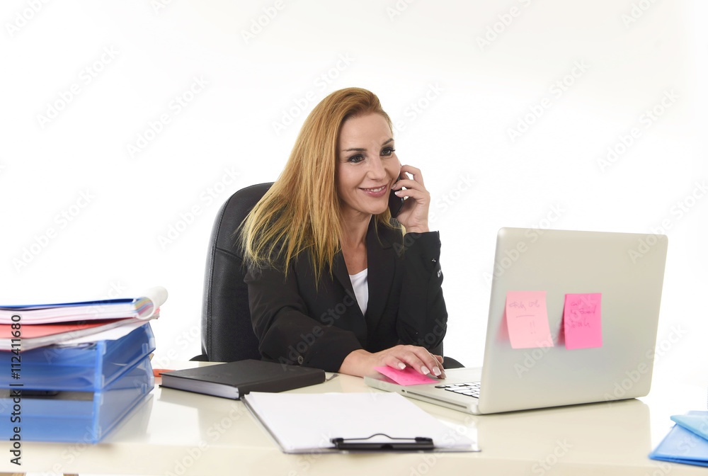 blond businesswoman working at office laptop computer desk talking on mobile phone smiling blond businesswoman working at office laptop computer desk talking on mobile phone smiling