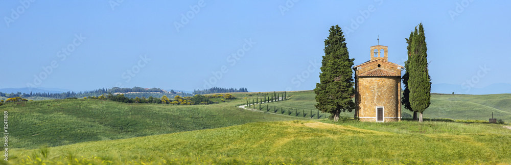 Fototapeta premium panorama with lonely chapel and cypress trees in Tuscany in Italy