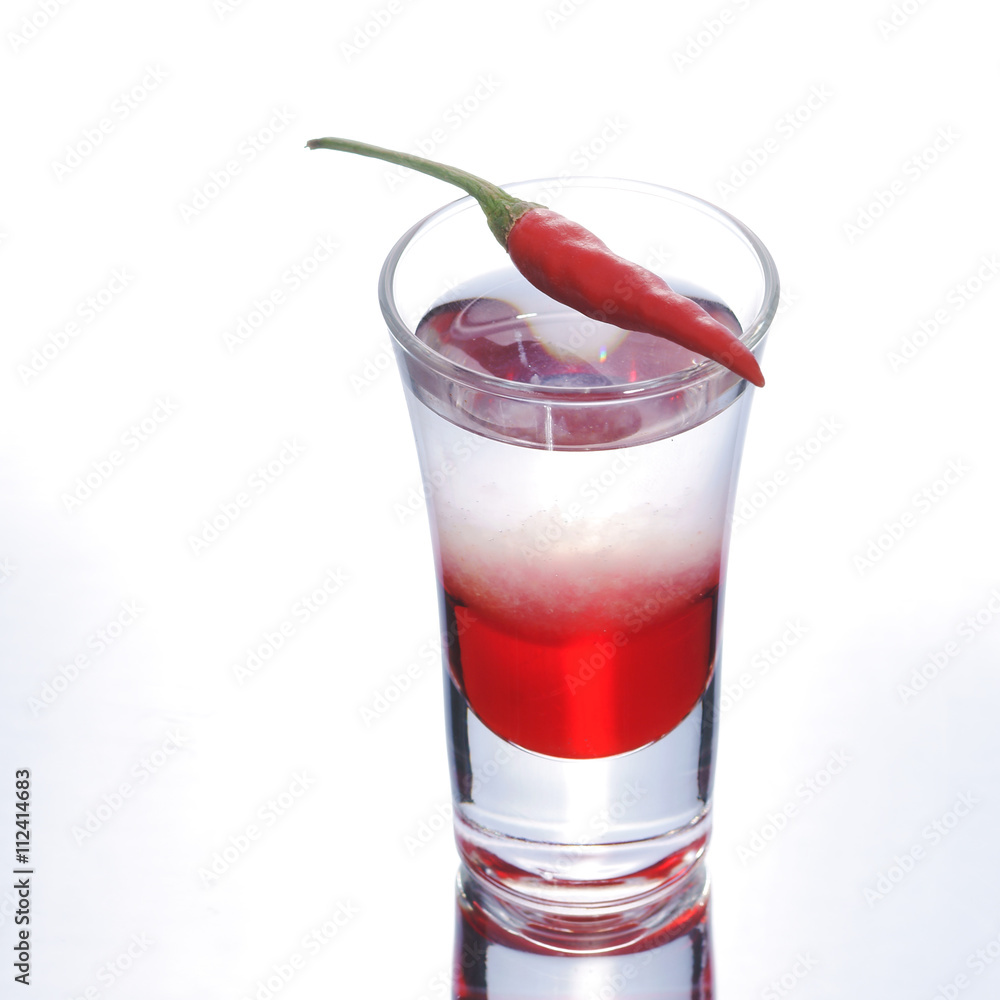 Colorful layered shot with reflection. Alcohol red shooter with chili pepper Colorful layered shot with reflection. Alcohol red shooter with chili pepper