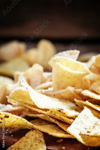 Mexican corn chips, nachos with salt, vintage wooden background,