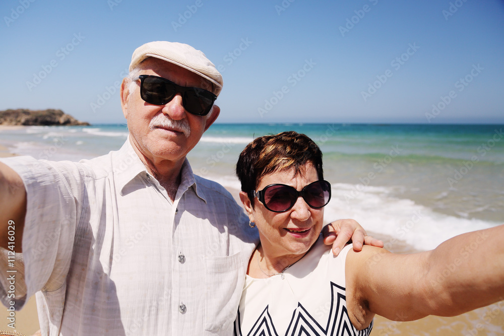senior couple walking on the beach senior couple walking on the beach