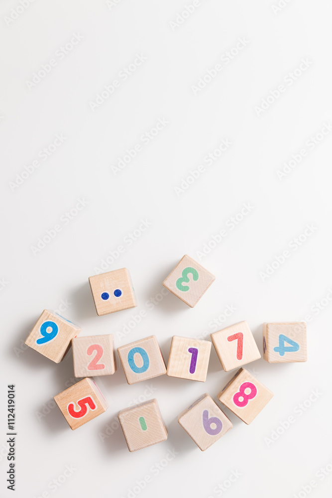 Top view on wooden cubes with numbers on a white background. Education and learning concept. 2017 school year. Flat lay. Top view on wooden cubes with numbers on a white background. Education and learning concept. 2017 school year. Flat lay.