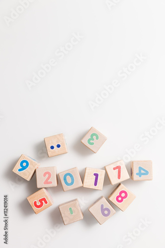 Top view on wooden cubes with numbers on a white background. Education and learning concept. 2017 school year. Flat lay.