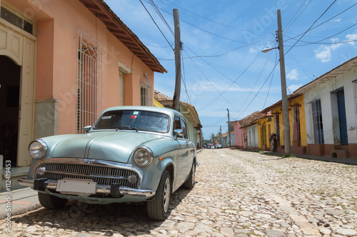 Classic american car parked on a typical cobblestone road in Trinidad, Cuba © Roberto Lusso