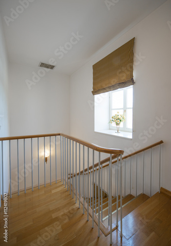 Two-storey studio apartment. Interior. A wooden staircase.