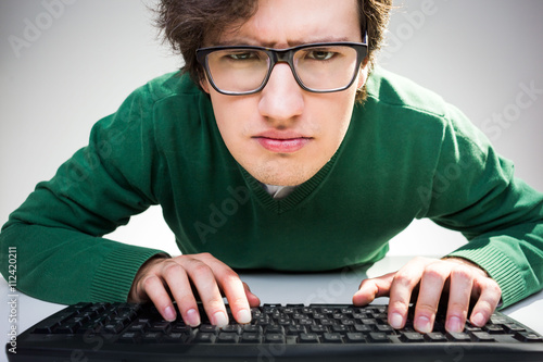 Man with keyboard looking closely