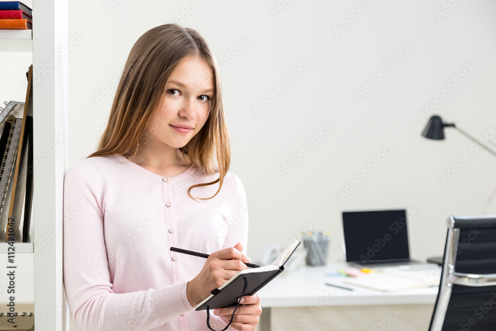 Smiling woman making notes