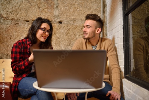 twenty something young couple working with his laptop