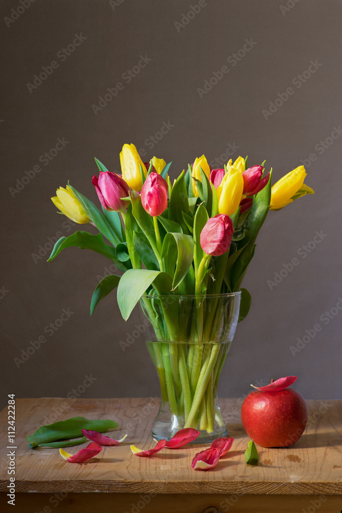 Fototapeta premium Still life with a bunch of yellow and red tulips