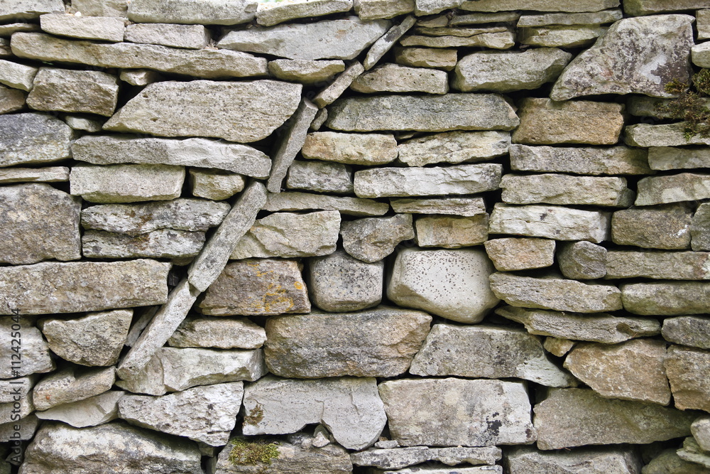 Fototapeta premium Curved circular texture pattern in a dry stone wall