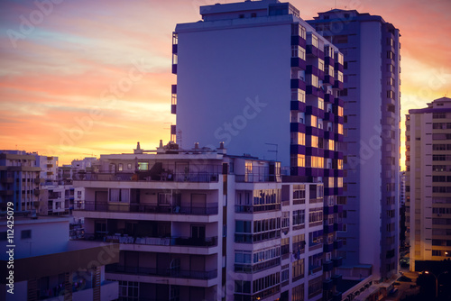 Modern buildings over dawn sky. City and sunrise sunset outdoors 