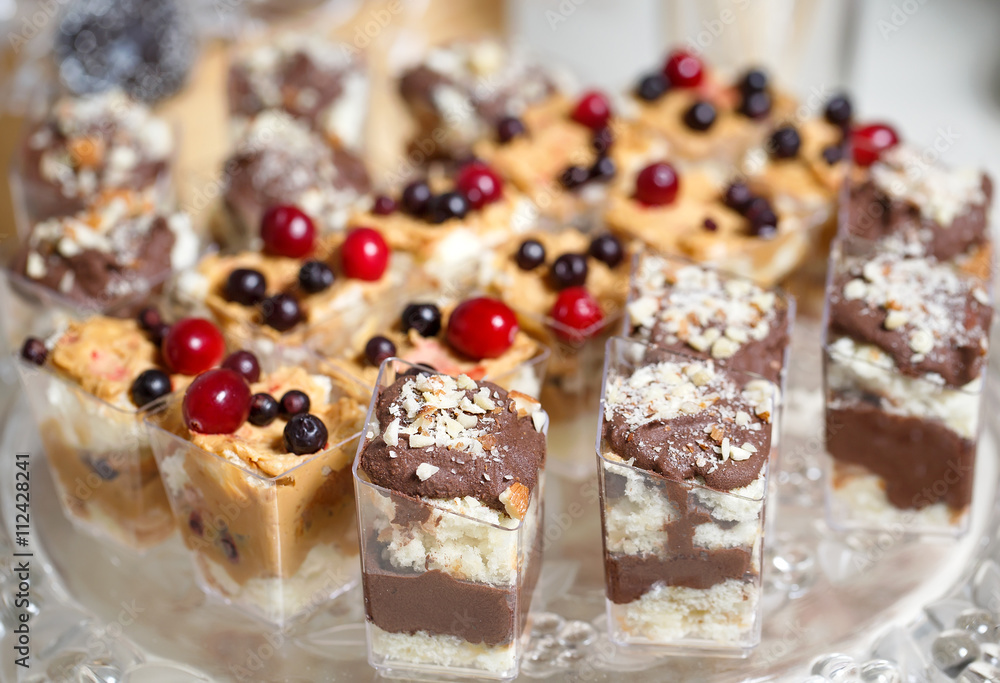 Sweet Dessert. Chocolate, nuts and berry pudding in small plasti Sweet Dessert. Chocolate, nuts and berry pudding in small plasti