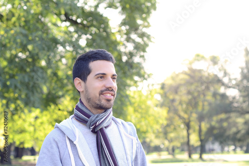 Close up of young man in a park.