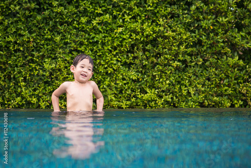 Asian child playing in swimming pool
