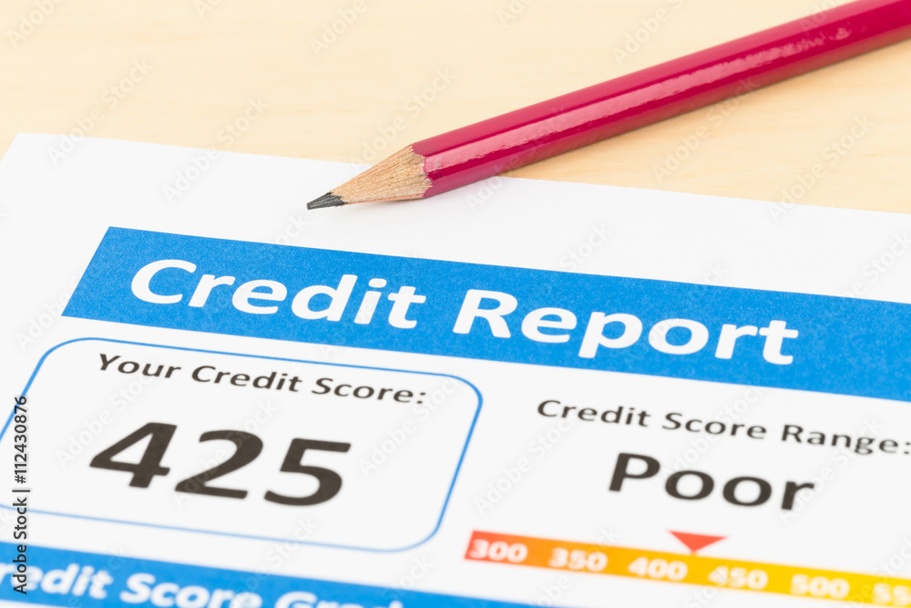 Poor credit score report with pen Poor credit score report with pen