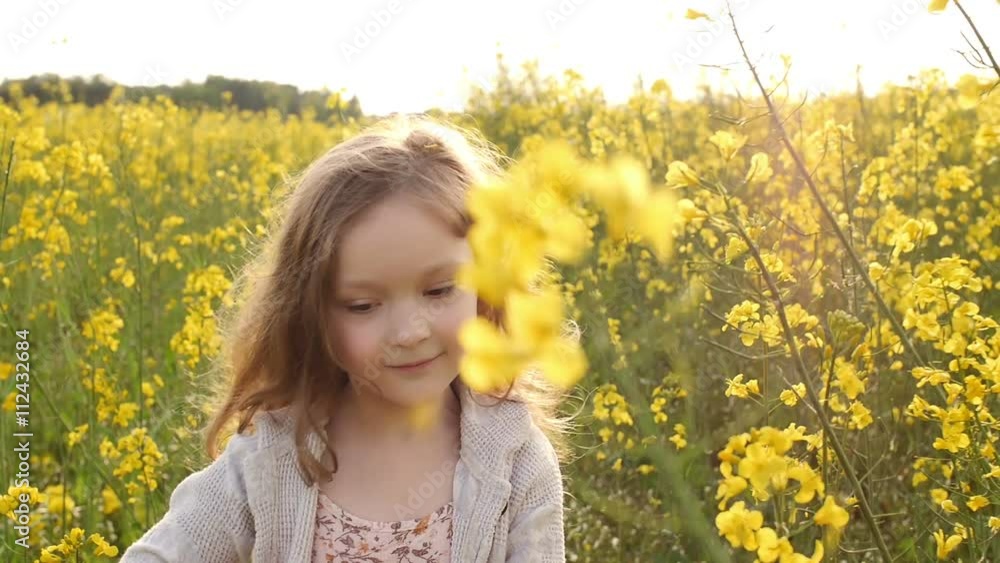 girl walking cross the field at sunset.Slow motion girl walking cross the field at sunset.Slow motion
