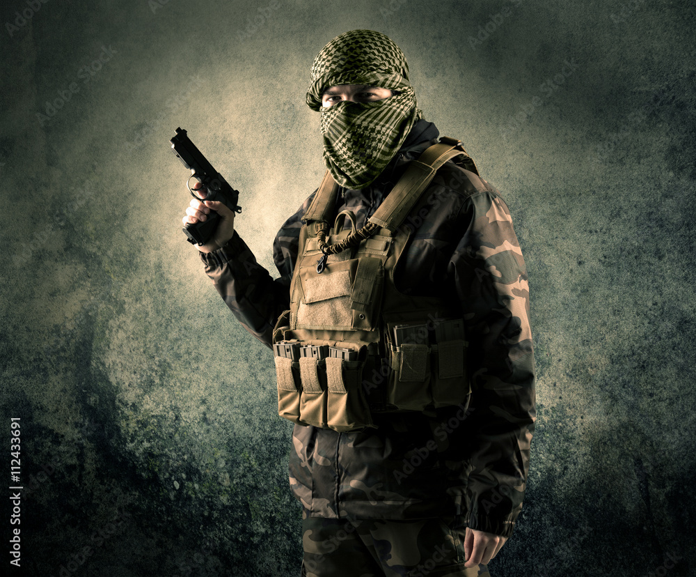 Portrait of a heavily armed masked soldier with grungy backgroun Portrait of a heavily armed masked soldier with grungy backgroun