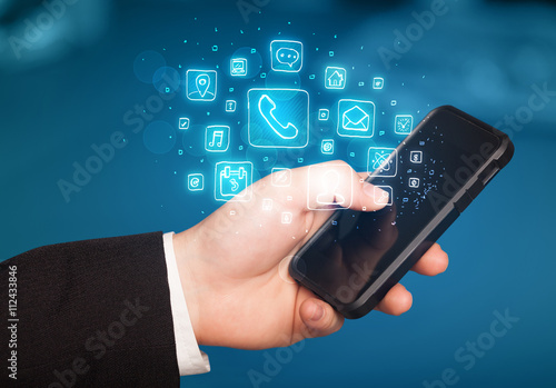 Wallpaper Mural Hand holding smartphone with mobile app icons Torontodigital.ca