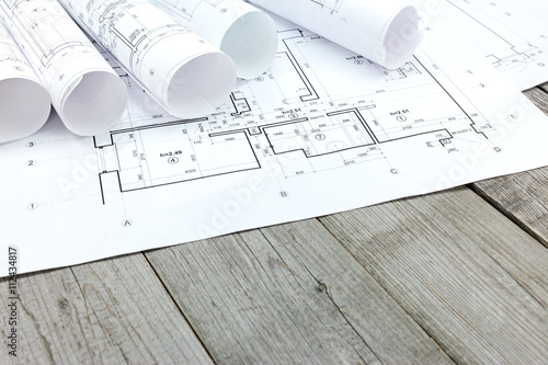 architectural blueprints with floor plan on gray wooden boards