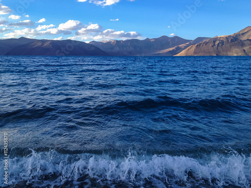 Pangong tso (Lake). It is huge lake in Ladakh, with snow peaks and blue sky in background, it extends from India to Tibet. Leh, Ladakh, Jammu and Kashmir, India