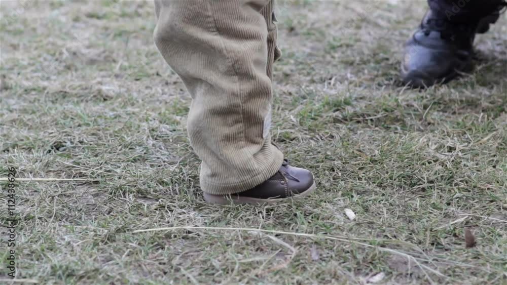child's first steps/baby feet taking the first steps in winter child's first steps/baby feet taking the first steps in winter