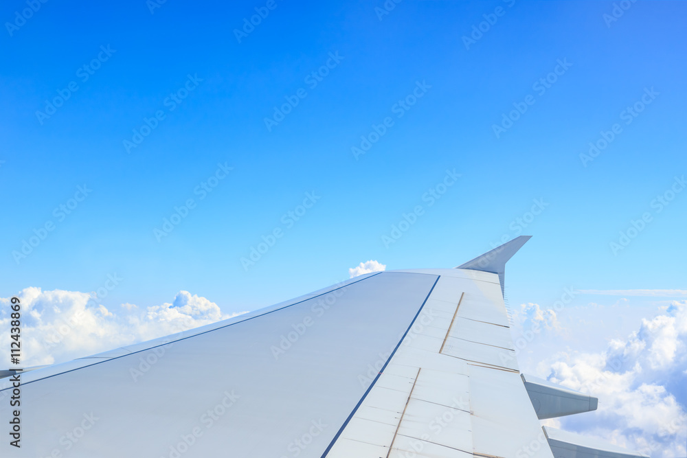 Fototapeta premium Airplane wing above cloud seen through window