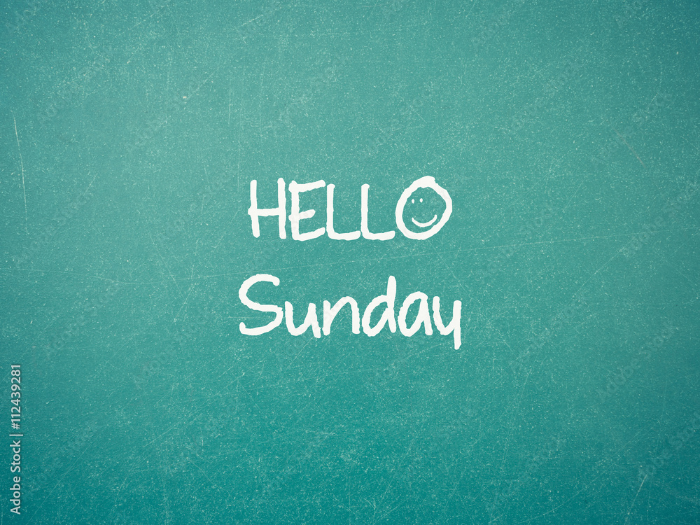 Green blackboard wall texture with a word Hello Sunday Green blackboard wall texture with a word Hello Sunday