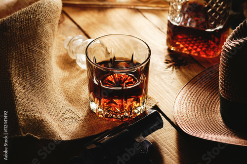 Glass of whiskey and hat