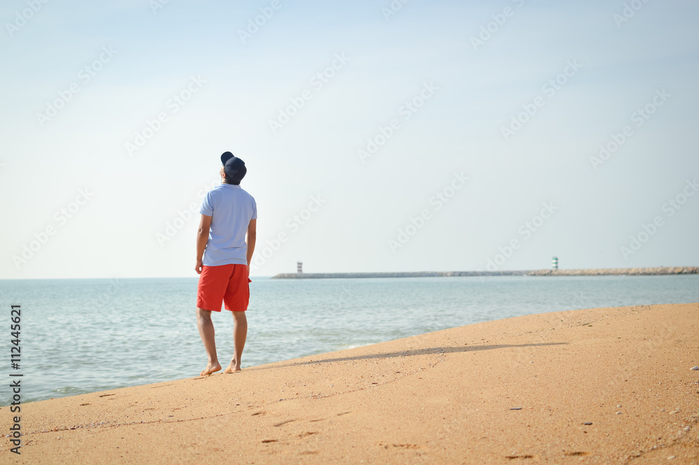 Man standing with the ocean in the background.