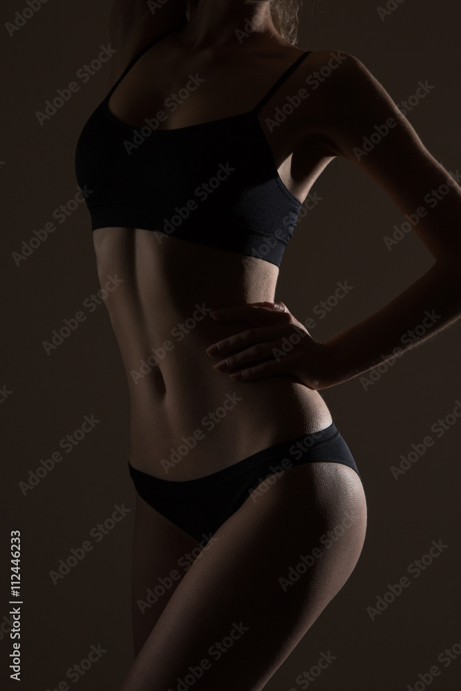 Naklejka premium silhouette of slim woman body in black low key