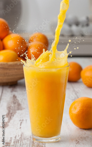 Orange juice pouring splash
